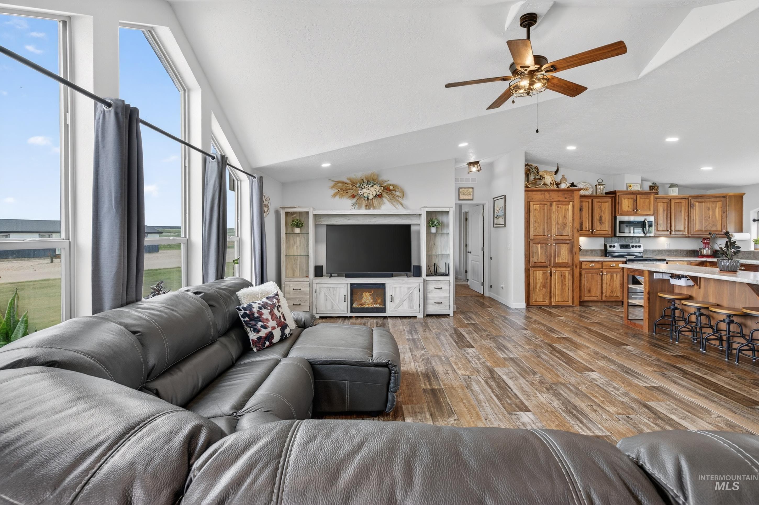 728 Chase Lane Melba, ID 83641 - Photo 9 of 48 Living area with a ceiling fan, lofted ceiling, light wood-style flooring, and recessed lighting
