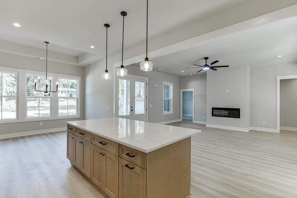 115 Rains Road Jefferson, GA 30549 - Photo 13 of 41 a kitchen with stainless steel appliances granite countertop a sink a oven and a wooden floors