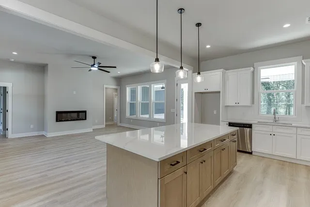 a kitchen with a stove a sink and a refrigerator