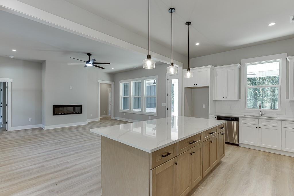 115 Rains Road Jefferson, GA 30549 - Photo 14 of 41 a kitchen with a stove a sink and a refrigerator