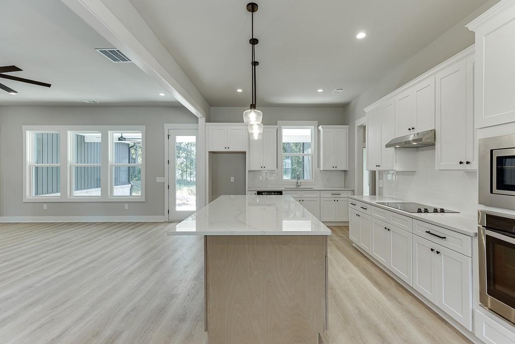 115 Rains Road Jefferson, GA 30549 - Photo 15 of 41 a large kitchen with granite countertop a large counter top appliances and cabinets