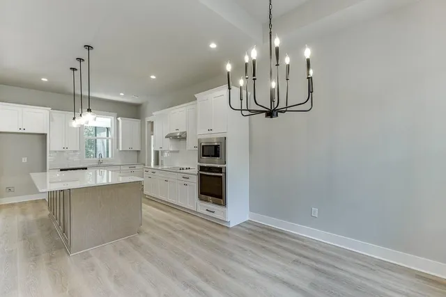 a view of a kitchen and kitchen island