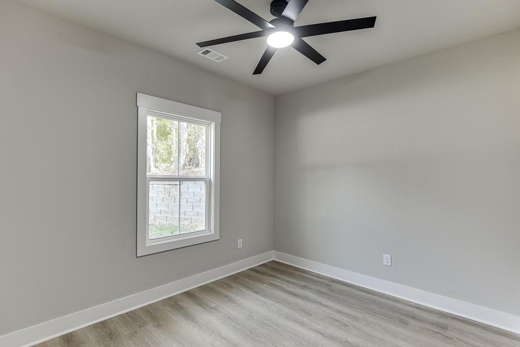 115 Rains Road Jefferson, GA 30549 - Photo 19 of 41 an empty room with a window and a fan