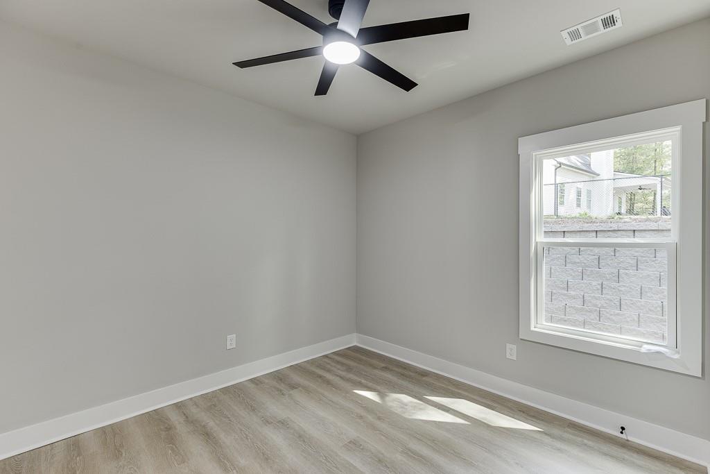 115 Rains Road Jefferson, GA 30549 - Photo 21 of 41 an empty room with a window and a ceiling fan