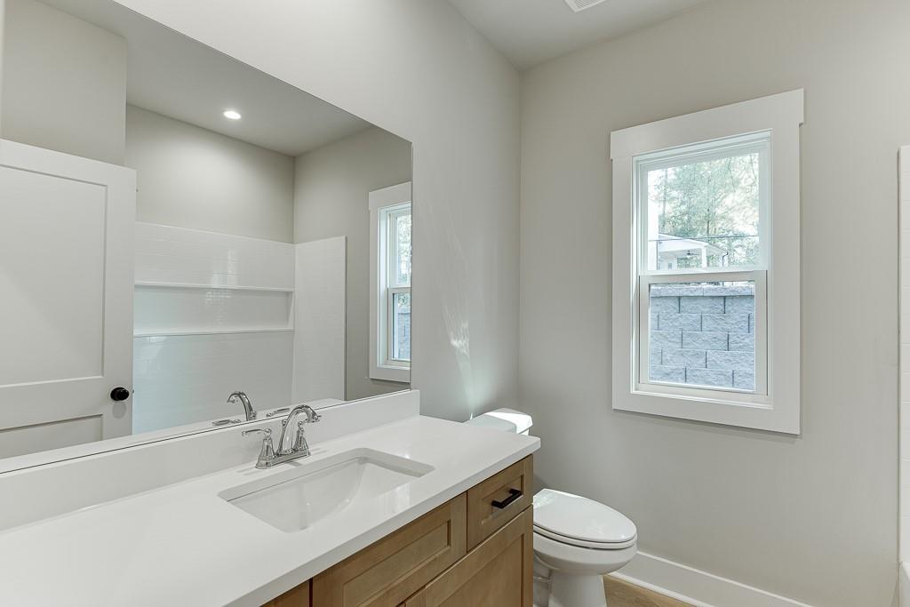 115 Rains Road Jefferson, GA 30549 - Photo 23 of 41 a bathroom with a sink toilet and a mirror