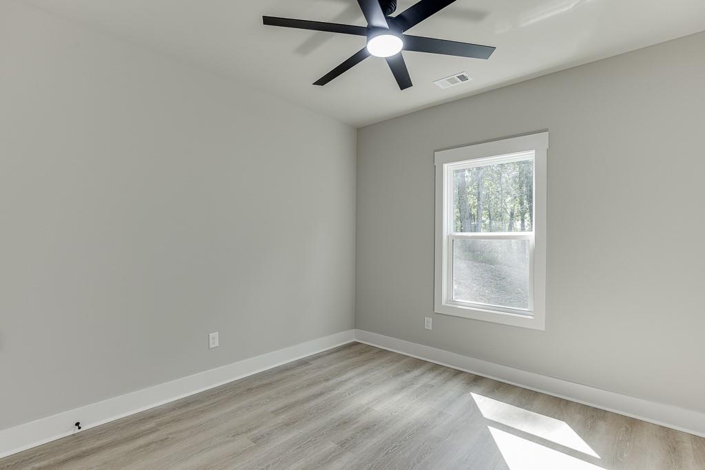 115 Rains Road Jefferson, GA 30549 - Photo 24 of 41 an empty room with a window and a fan