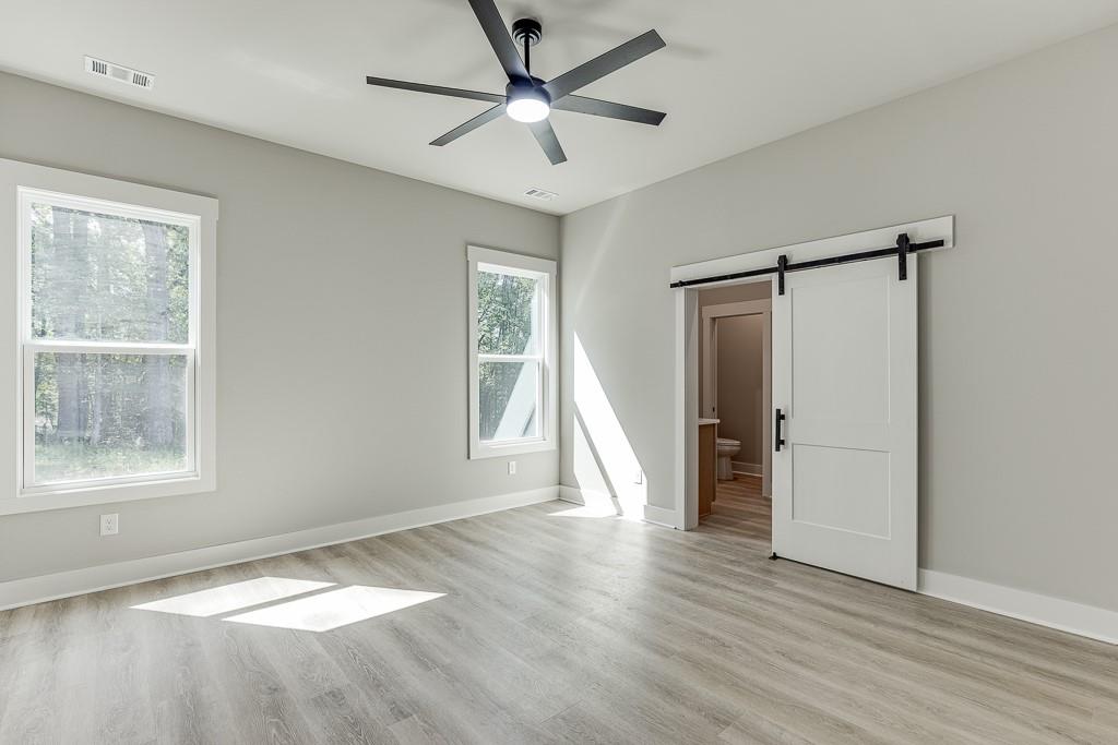 115 Rains Road Jefferson, GA 30549 - Photo 27 of 41 a view of an empty room with a window and wooden floor