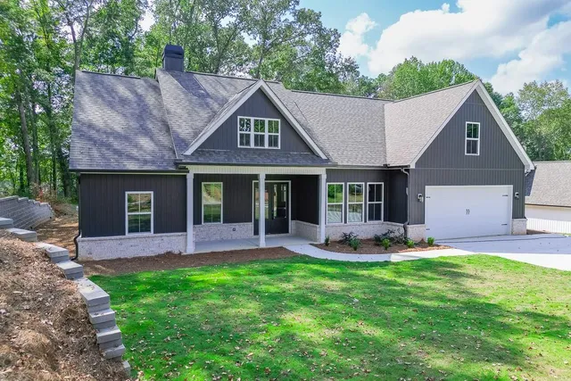 a front view of a house with a garden and patio