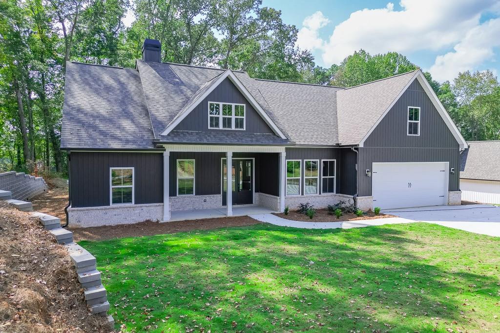 115 Rains Road Jefferson, GA 30549 - Photo 3 of 41 a front view of a house with a garden and patio
