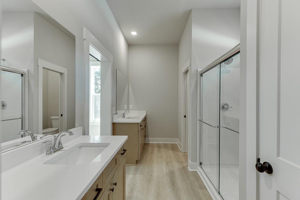 115 Rains Road Jefferson, GA 30549 - Photo 32 of 41 a bathroom with a double vanity sink mirror and shower