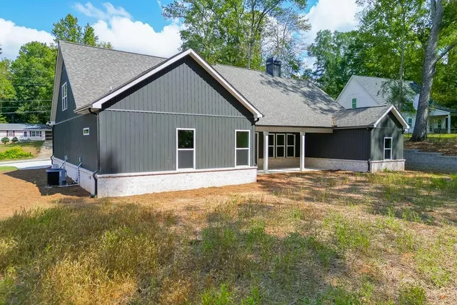 a view of house with backyard and swimming pool