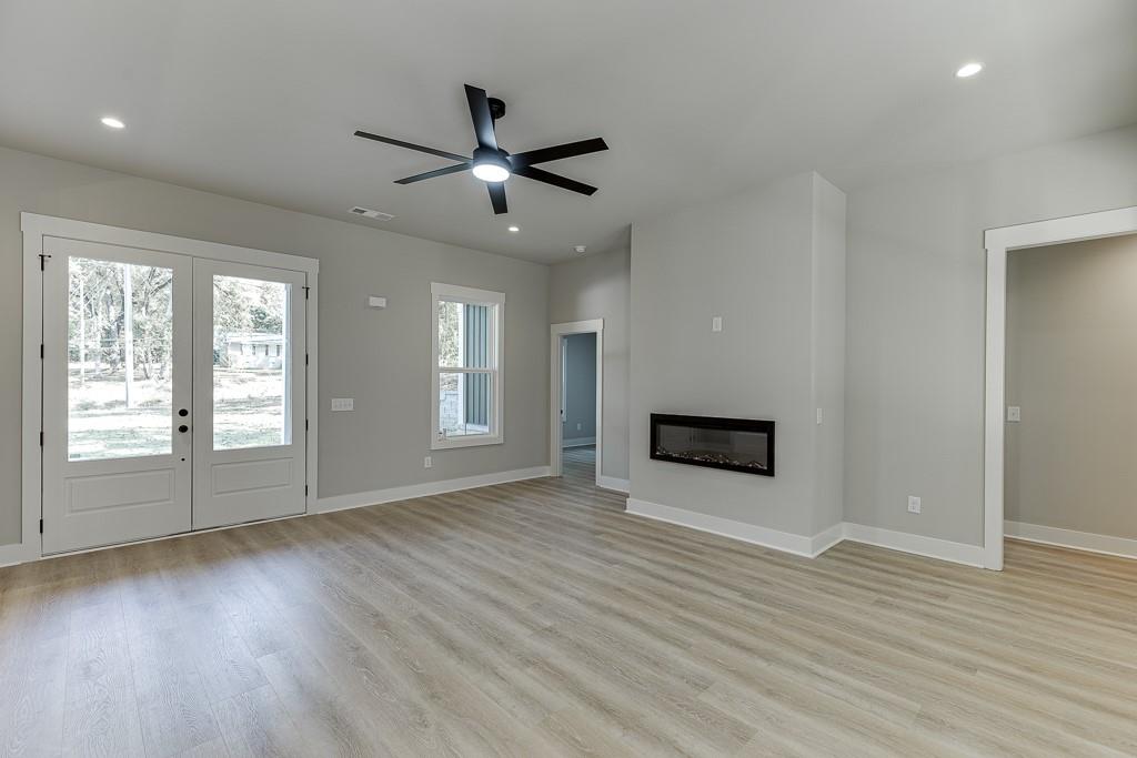 115 Rains Road Jefferson, GA 30549 - Photo 7 of 41 a view of an empty room with wooden floor and a window