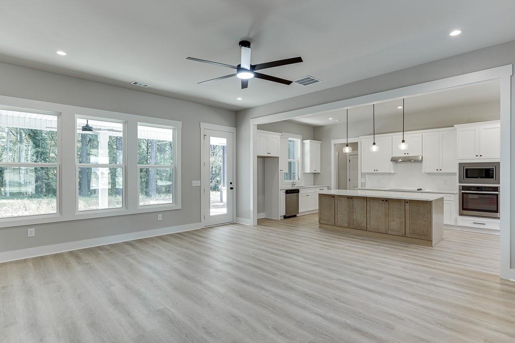 115 Rains Road Jefferson, GA 30549 - Photo 8 of 41 a view of an empty room with kitchen appliances and a window