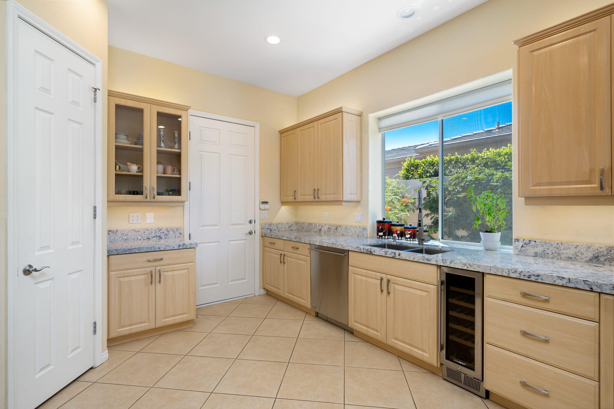 5 Lyon Road Rancho Mirage, CA 92270 - Photo 26 of 50 a kitchen with a stove a sink and a refrigerator