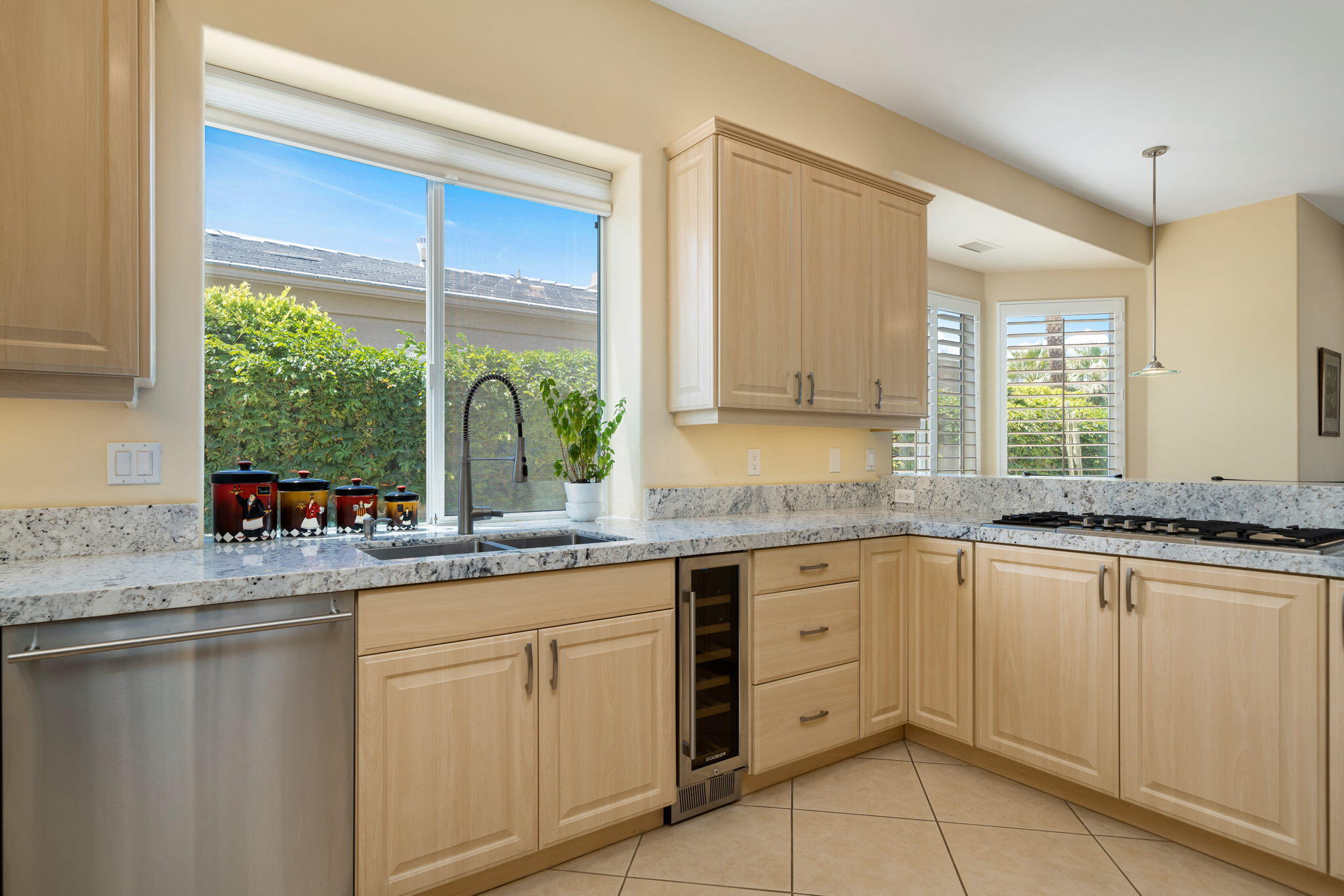 5 Lyon Road Rancho Mirage, CA 92270 - Photo 27 of 50 a kitchen with white cabinets and a window