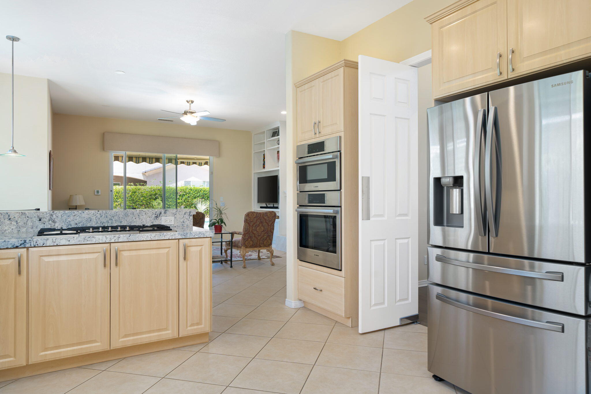 5 Lyon Road Rancho Mirage, CA 92270 - Photo 28 of 50 a kitchen with stainless steel appliances granite countertop a refrigerator and a stove top oven