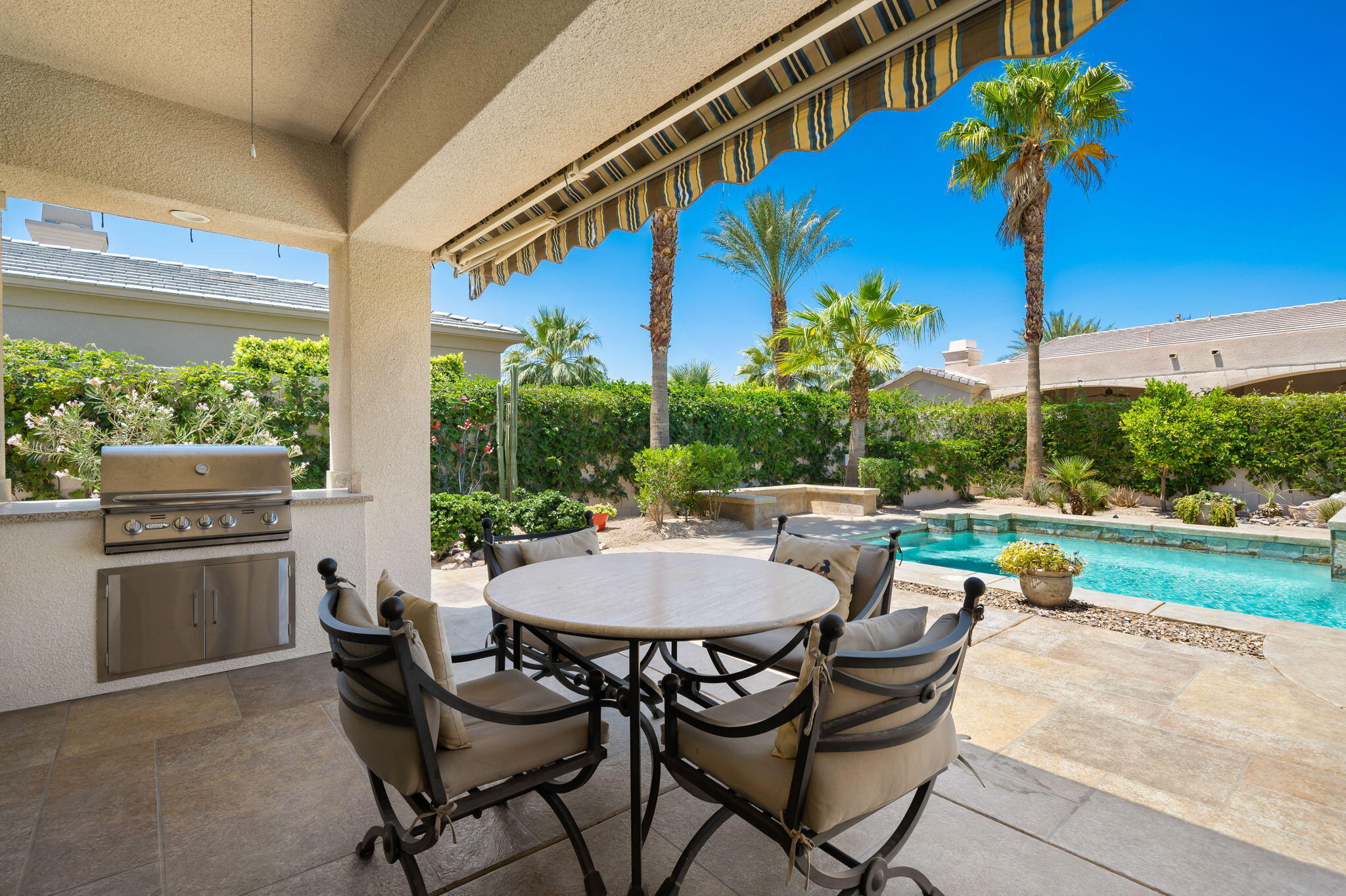 5 Lyon Road Rancho Mirage, CA 92270 - Photo 29 of 50 a view of a patio with a table and chairs