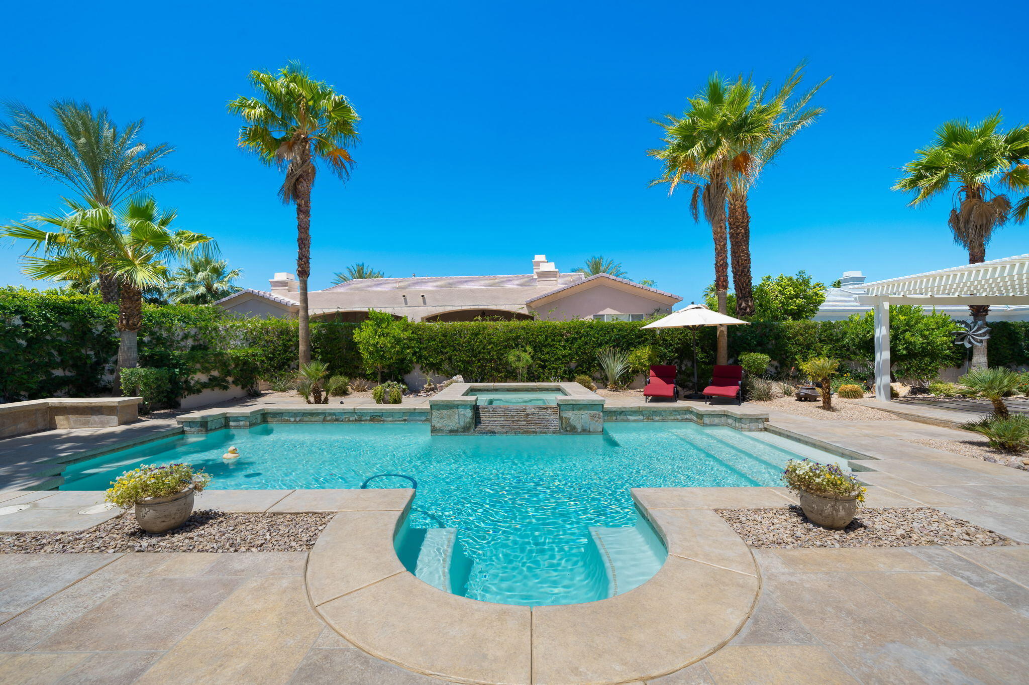 5 Lyon Road Rancho Mirage, CA 92270 - Photo 30 of 50 a view of a garden with a slide and a table