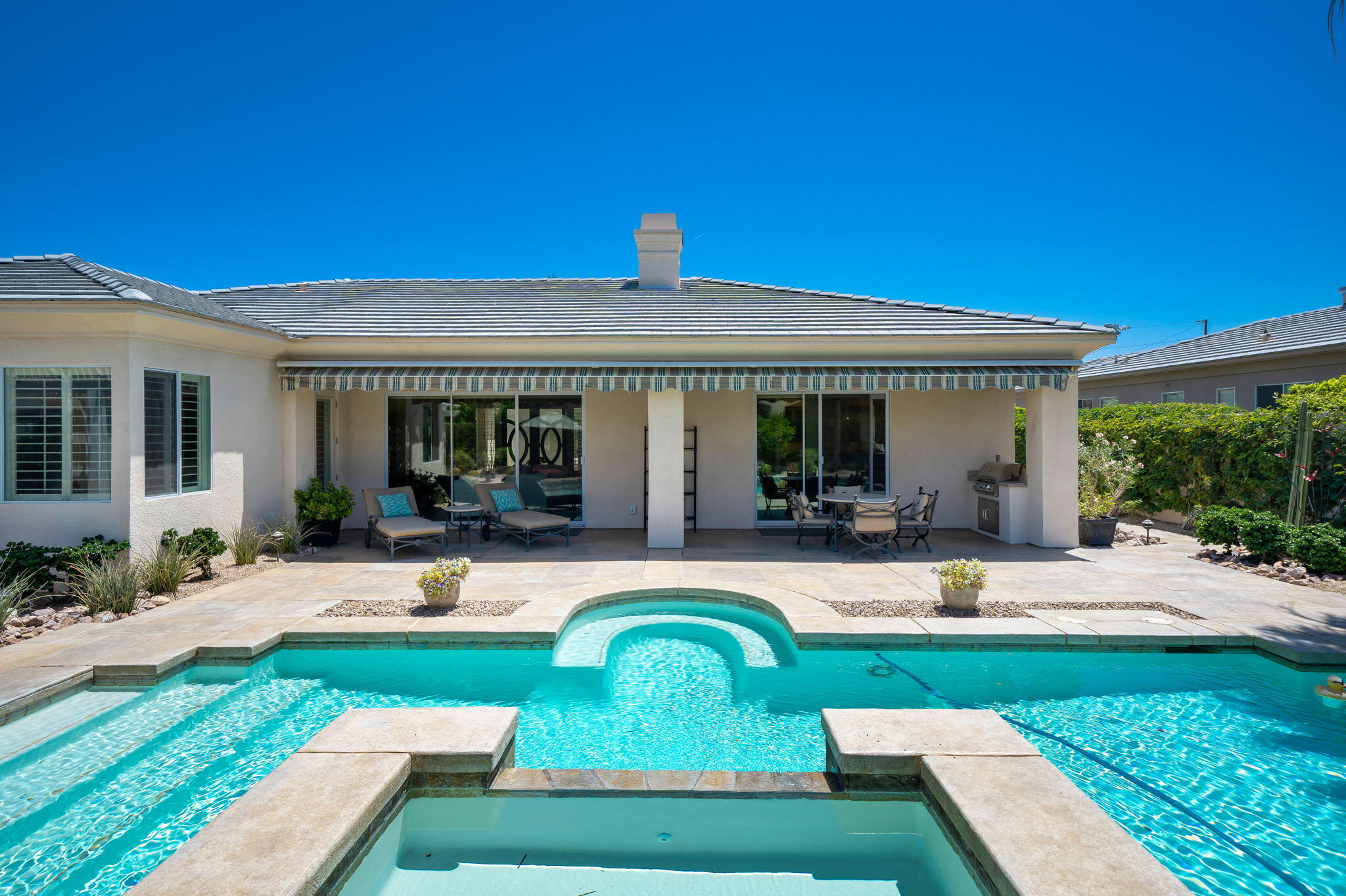 5 Lyon Road Rancho Mirage, CA 92270 - Photo 34 of 50 a view of a house with swimming pool and sitting area