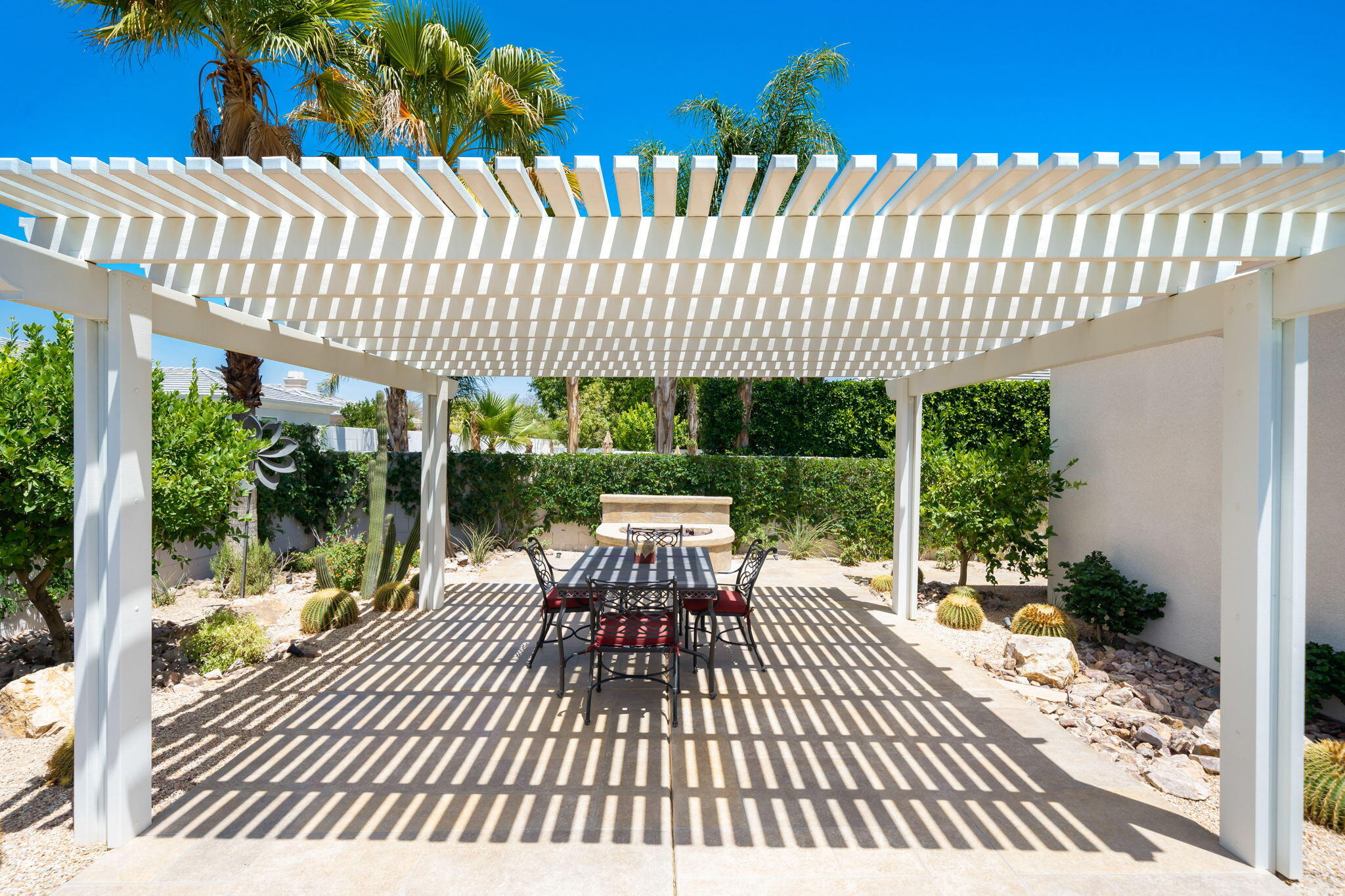 5 Lyon Road Rancho Mirage, CA 92270 - Photo 36 of 50 a view of a patio with a table and chairs