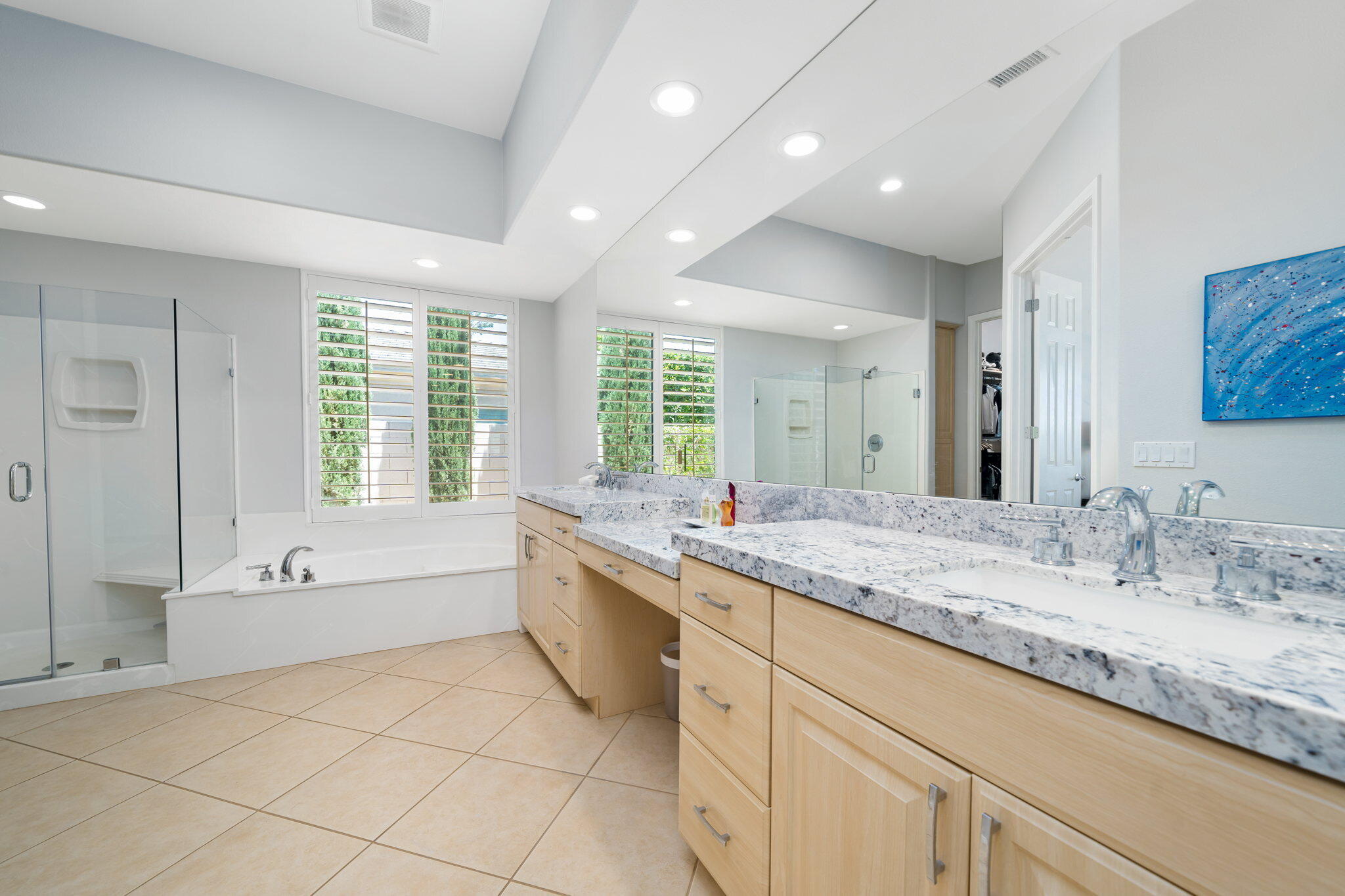 5 Lyon Road Rancho Mirage, CA 92270 - Photo 41 of 50 a large bathroom with a granite countertop tub sink and mirror
