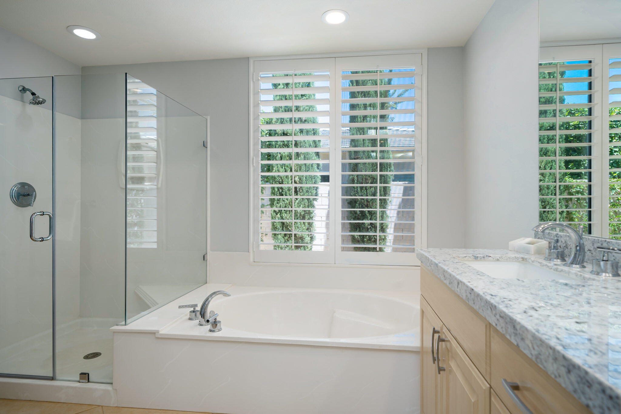 5 Lyon Road Rancho Mirage, CA 92270 - Photo 42 of 50 a bathroom with a granite countertop sink and a bathtub