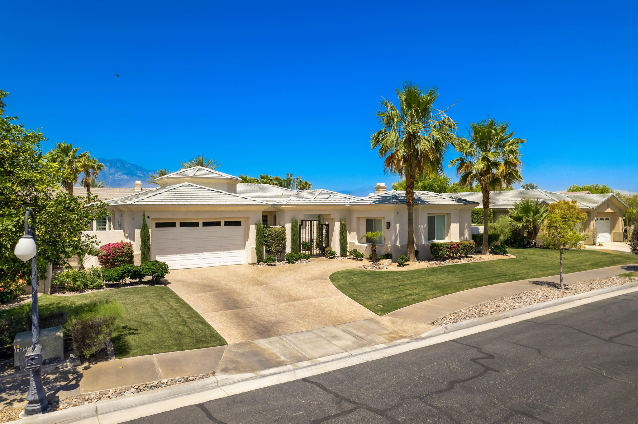 5 Lyon Road Rancho Mirage, CA 92270 - Photo 5 of 50 a front view of a house with a yard and garage
