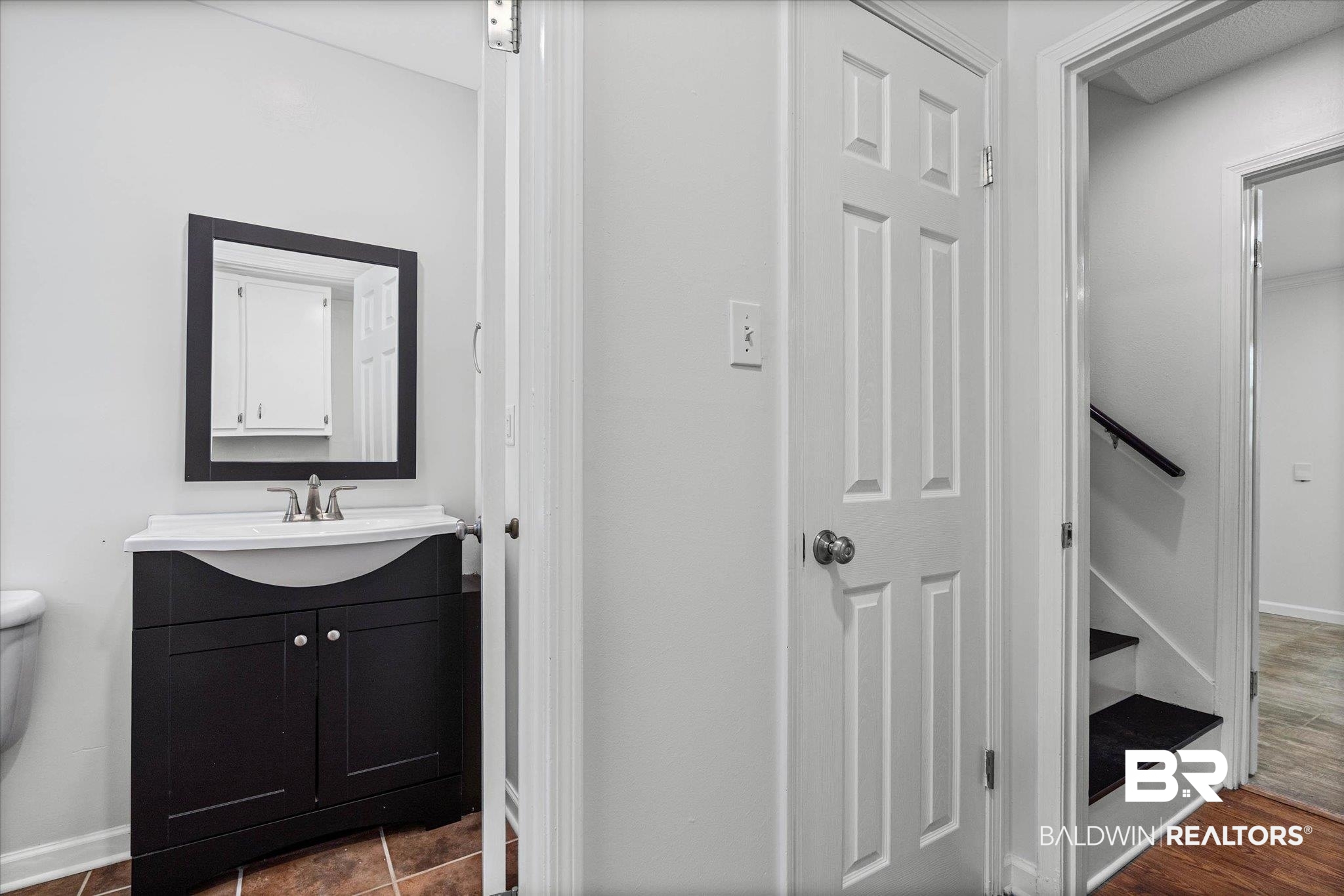 8301 Fordham Road Mobile, AL 36619 - Photo 26 of 57 Bathroom vanity with a dark wood-finish cabinet and white countertop sink