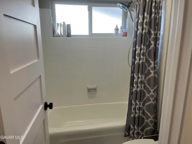 a bathroom with a bathtub and shower