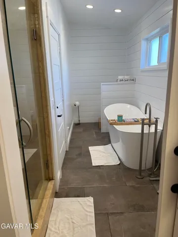 a white bath tub sitting in a bathroom