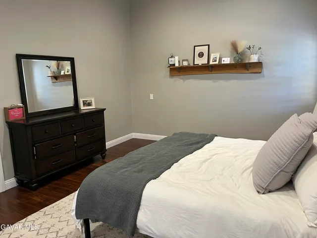 a bedroom with a bed and cabinet