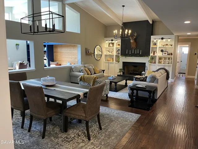 a living room with furniture a fireplace and a chandelier