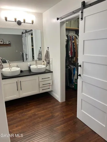 a bedroom with a bed and a large mirror