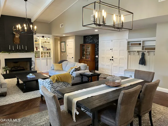 a living room with furniture a chandelier and a fireplace