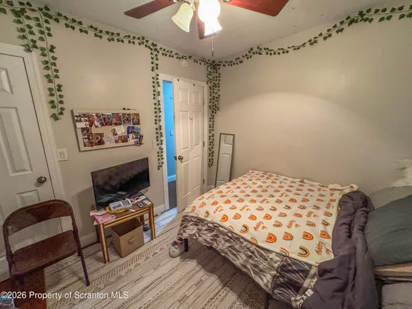 a bedroom with bed and a mirror