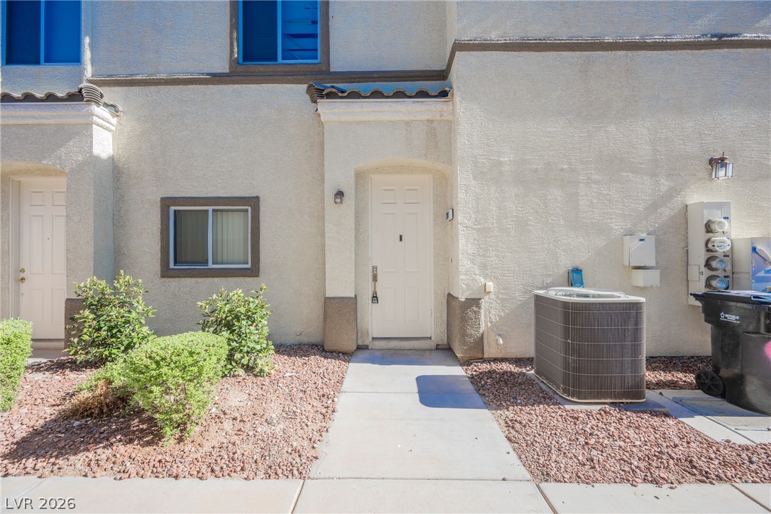 6320 Snap Ridge Street, Unit 201 North Las Vegas, NV 89081 - Photo 50 of 56 A welcoming front entrance, framed by mature shrubbery, features a clean walkway leading to the home.