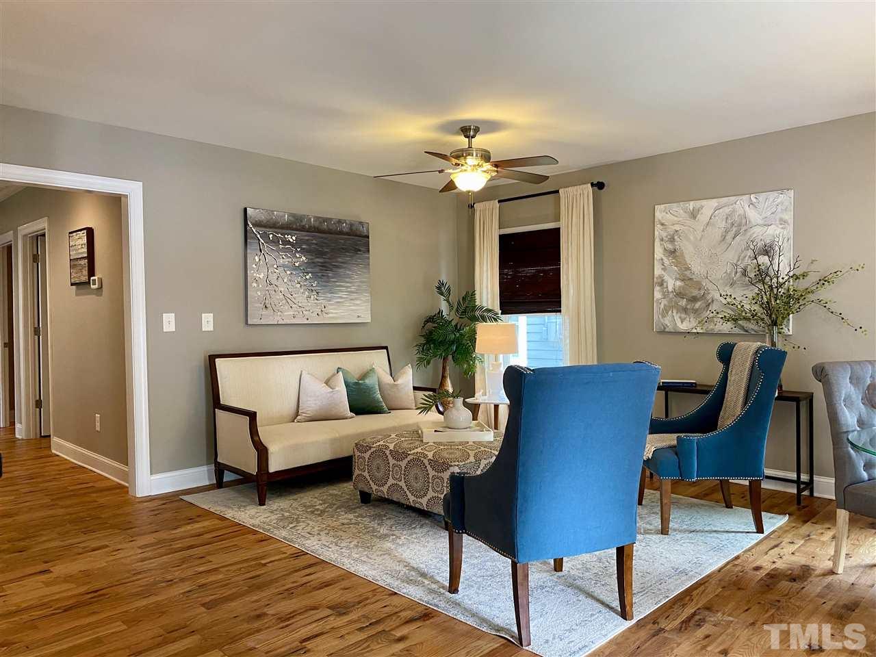 818 Ellington Street Raleigh, NC 27601 - Photo 2 of 20 a living room with furniture a chandelier and a rug