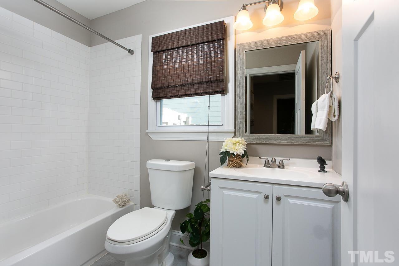 818 Ellington Street Raleigh, NC 27601 - Photo 15 of 20 a bathroom with a sink toilet tub and shower
