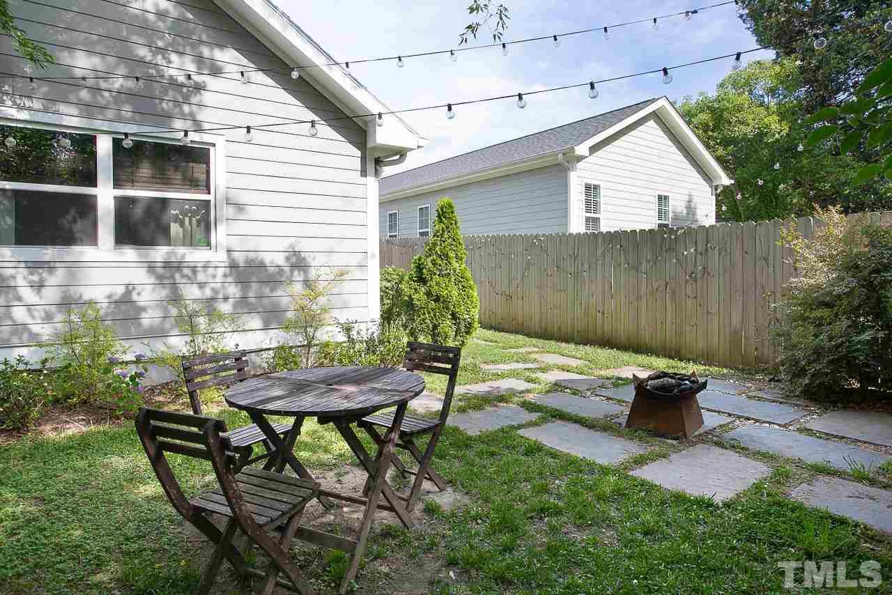 818 Ellington Street Raleigh, NC 27601 - Photo 18 of 20 a backyard of a house with table and chairs