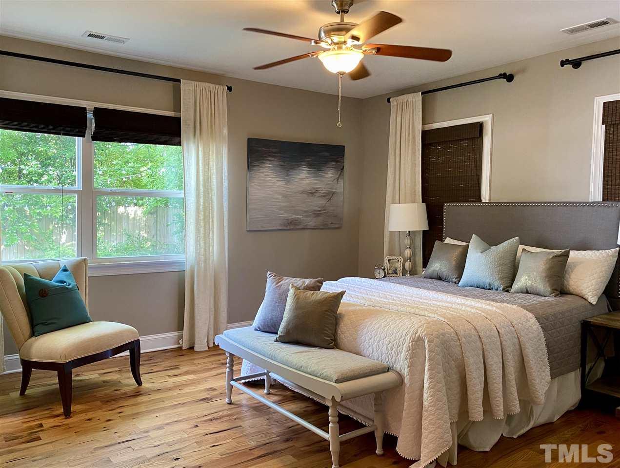 818 Ellington Street Raleigh, NC 27601 - Photo 5 of 20 a bedroom with a bed and a chair