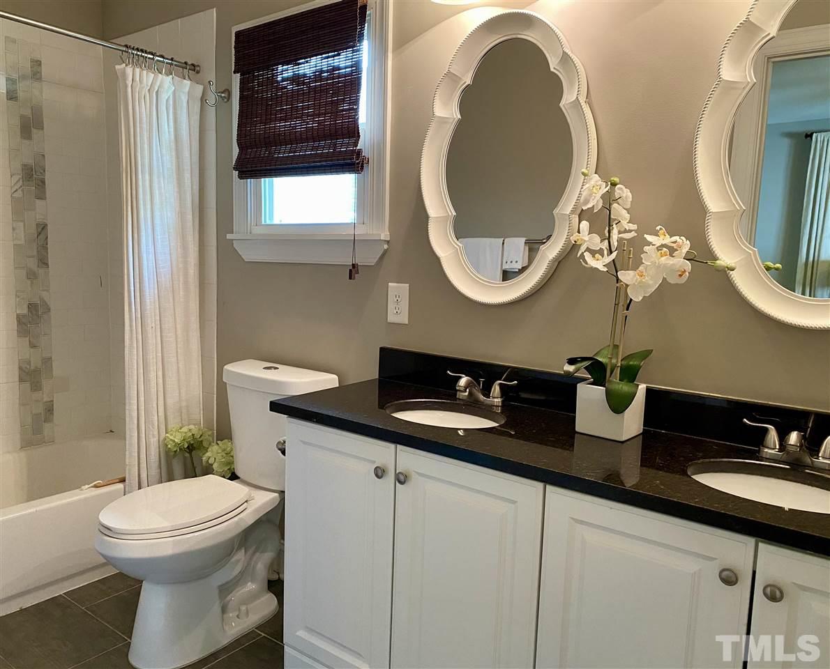 818 Ellington Street Raleigh, NC 27601 - Photo 6 of 20 a bathroom with a toilet a sink and a mirror