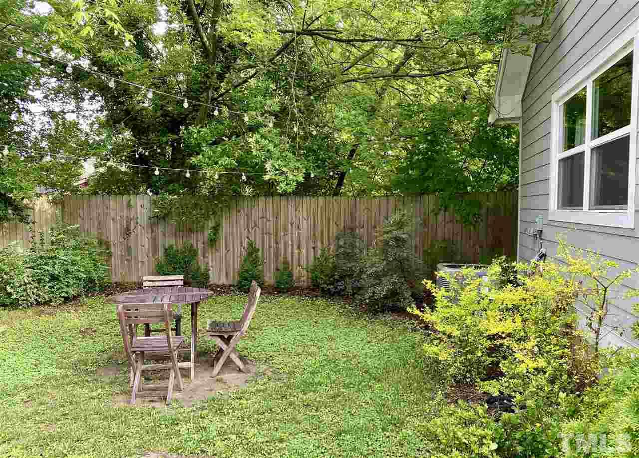 818 Ellington Street Raleigh, NC 27601 - Photo 8 of 20 a garden with a bench and some trees