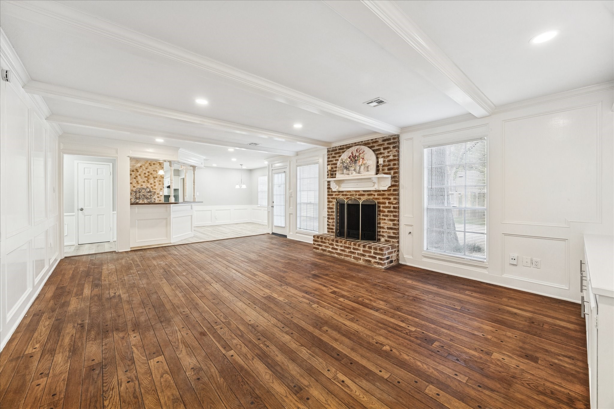 1502 Big Horn Drive Houston, TX 77090 - Photo 11 of 36 an empty room with wooden floor and fireplace