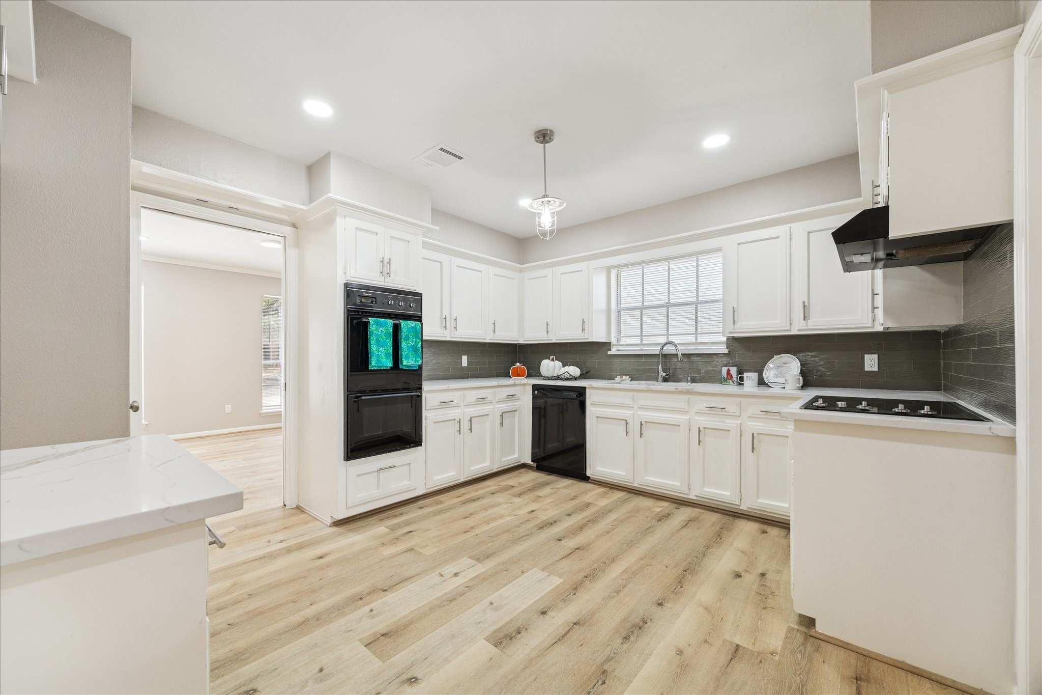 1502 Big Horn Drive Houston, TX 77090 - Photo 17 of 36 a kitchen with stove cabinets and refrigerator