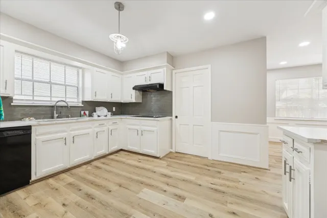 a kitchen with granite countertop white cabinets and white appliances