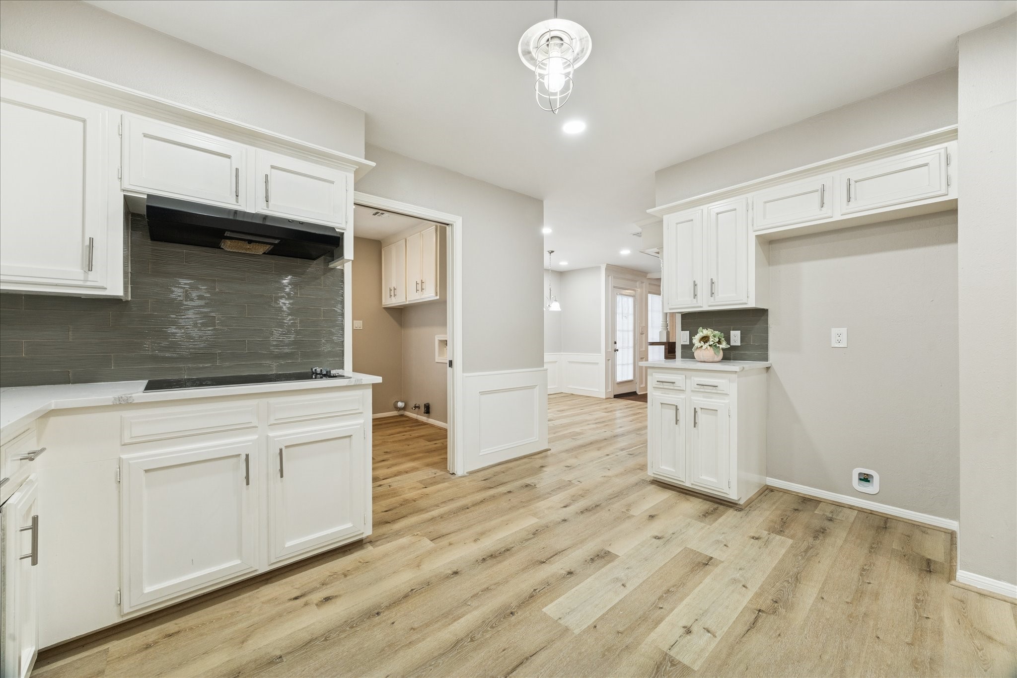 1502 Big Horn Drive Houston, TX 77090 - Photo 19 of 36 a kitchen with granite countertop white cabinets and white appliances