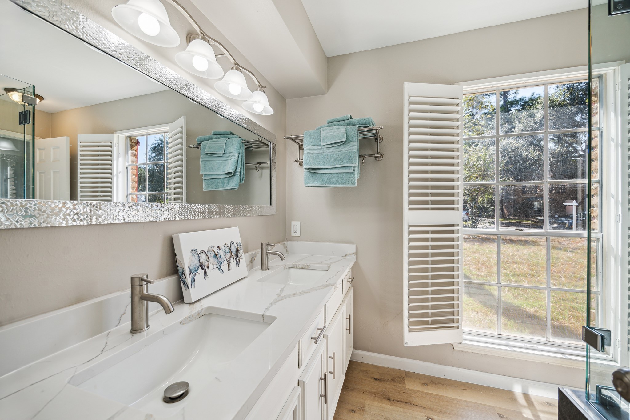 1502 Big Horn Drive Houston, TX 77090 - Photo 24 of 36 a bathroom with a granite countertop sink and a large mirror