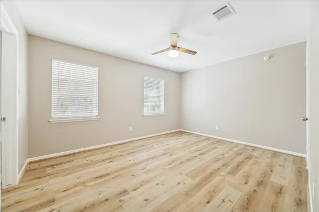 wooden floor in an empty room with a window