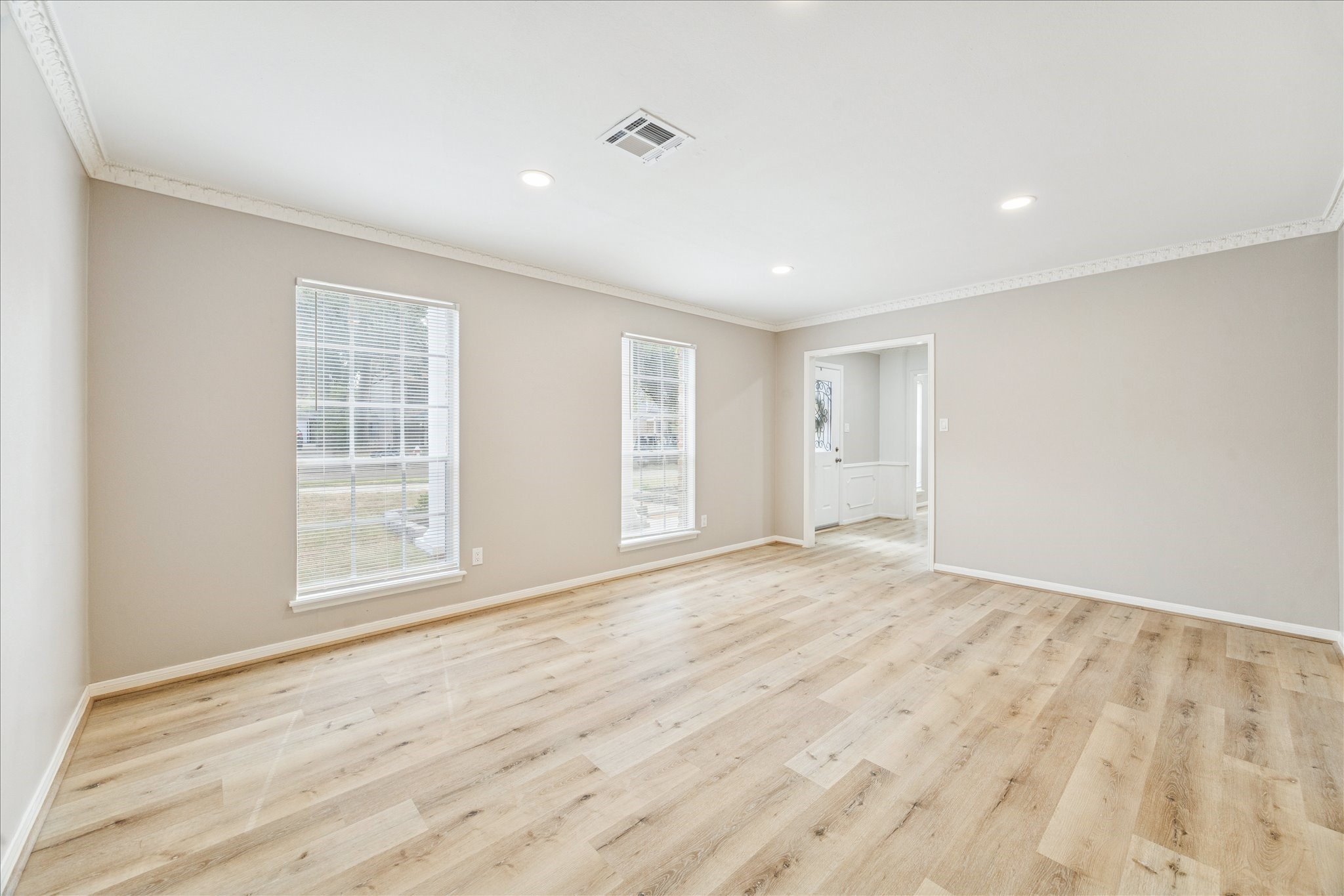 1502 Big Horn Drive Houston, TX 77090 - Photo 6 of 36 a view of an empty room with wooden floor and a window