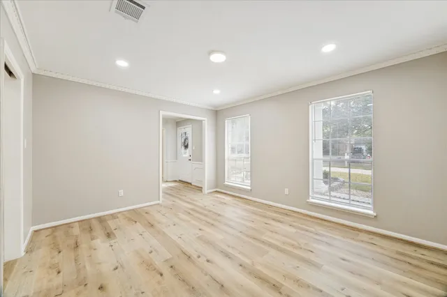 wooden floor in an empty room with a window